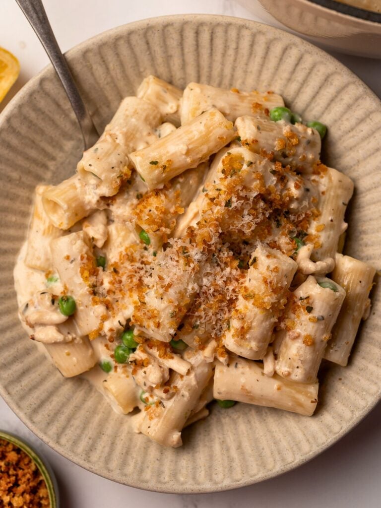 a bowl of cottage cheese chicken alfredo with a fork in it