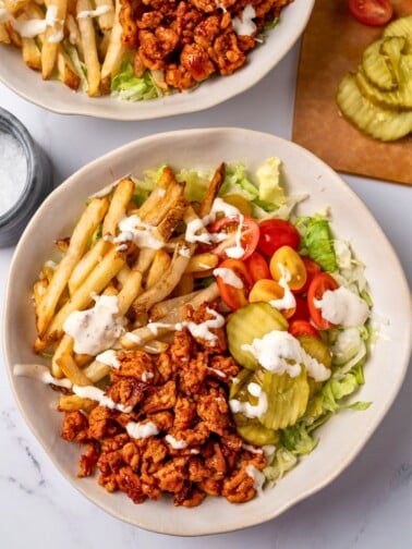 honey chipotle ground turkey in a bowl with lettuce, tomatoes, pickles, ranch, and air fryer fries