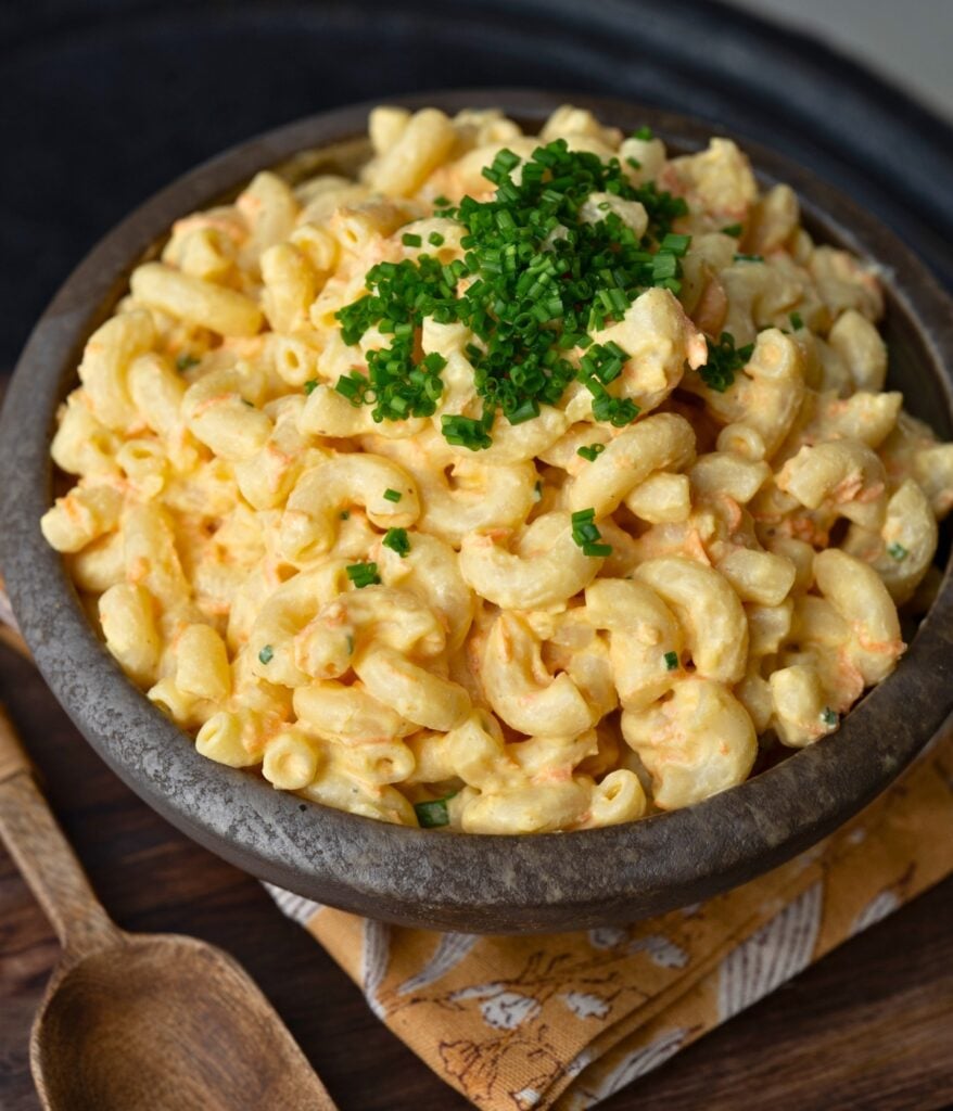 a bowl of macaroni salad garnished with chives