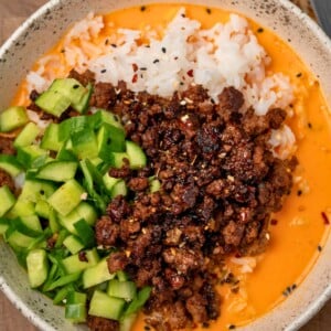 sesame ground beef and rice with creamy gochujang broth and cucumbers