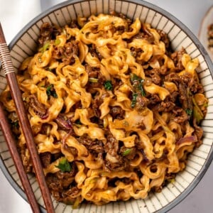 chopsticks on a bowl of beef noodles