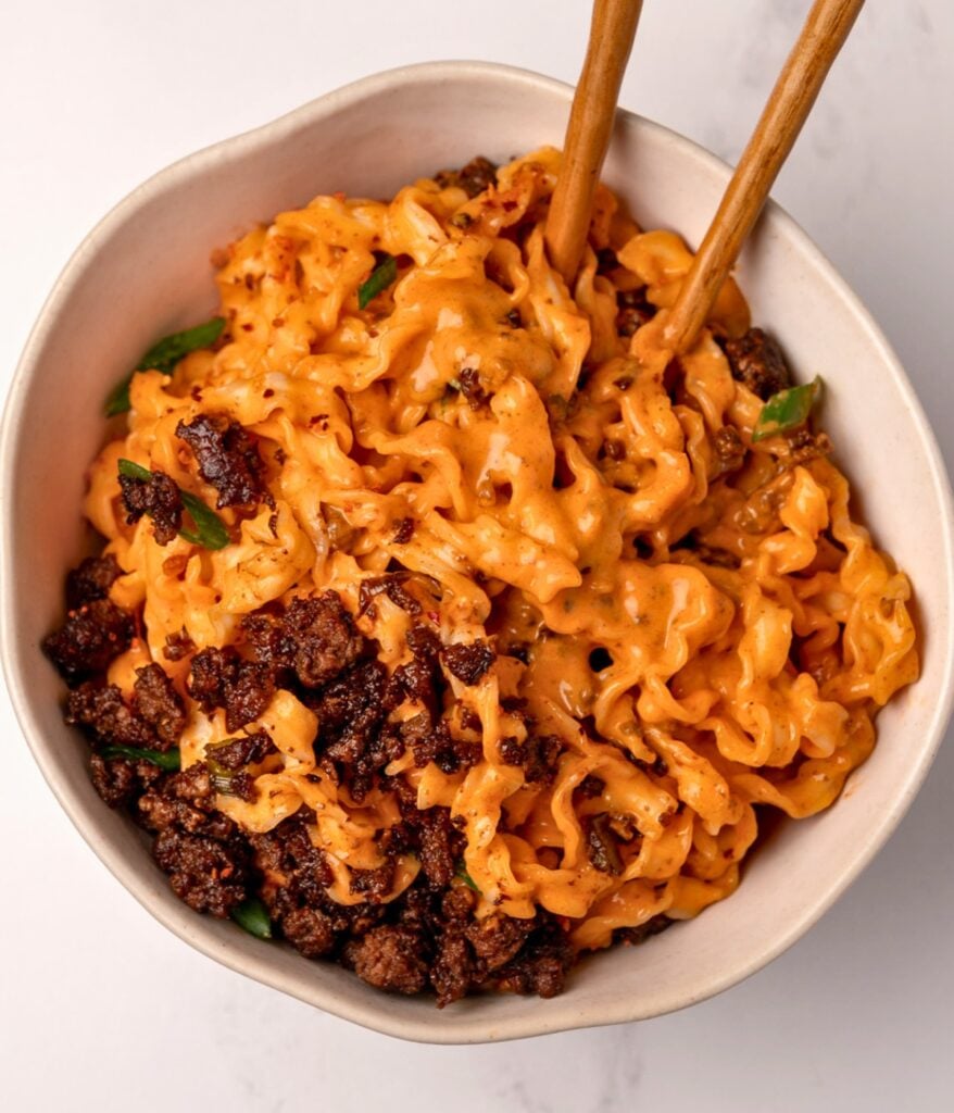 creamy noodles and crispy ground beef in a bowl with chopsticks