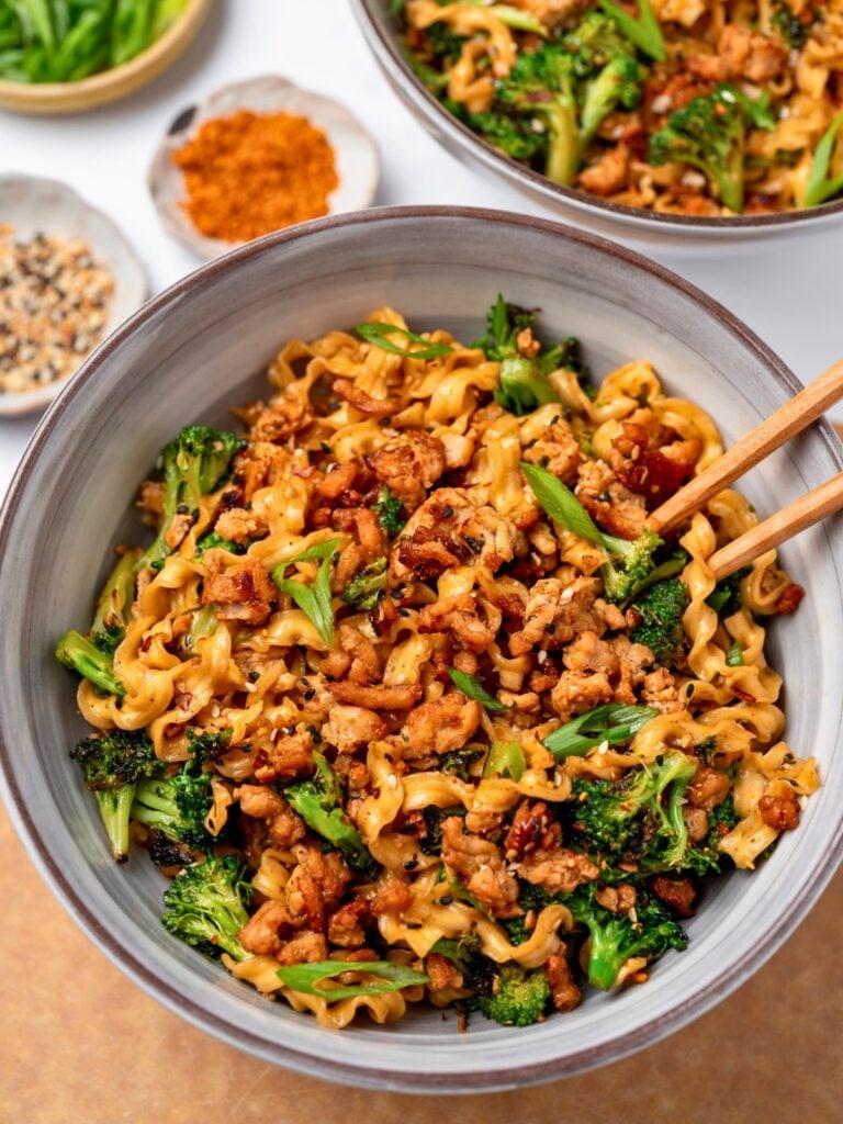 chopsticks in a bowl of teriyaki noodles