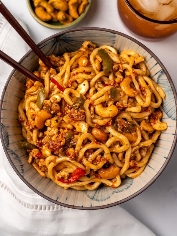 a bowl of Trader Joe's Thai wheat noodles with cashew chicken and chopsticks