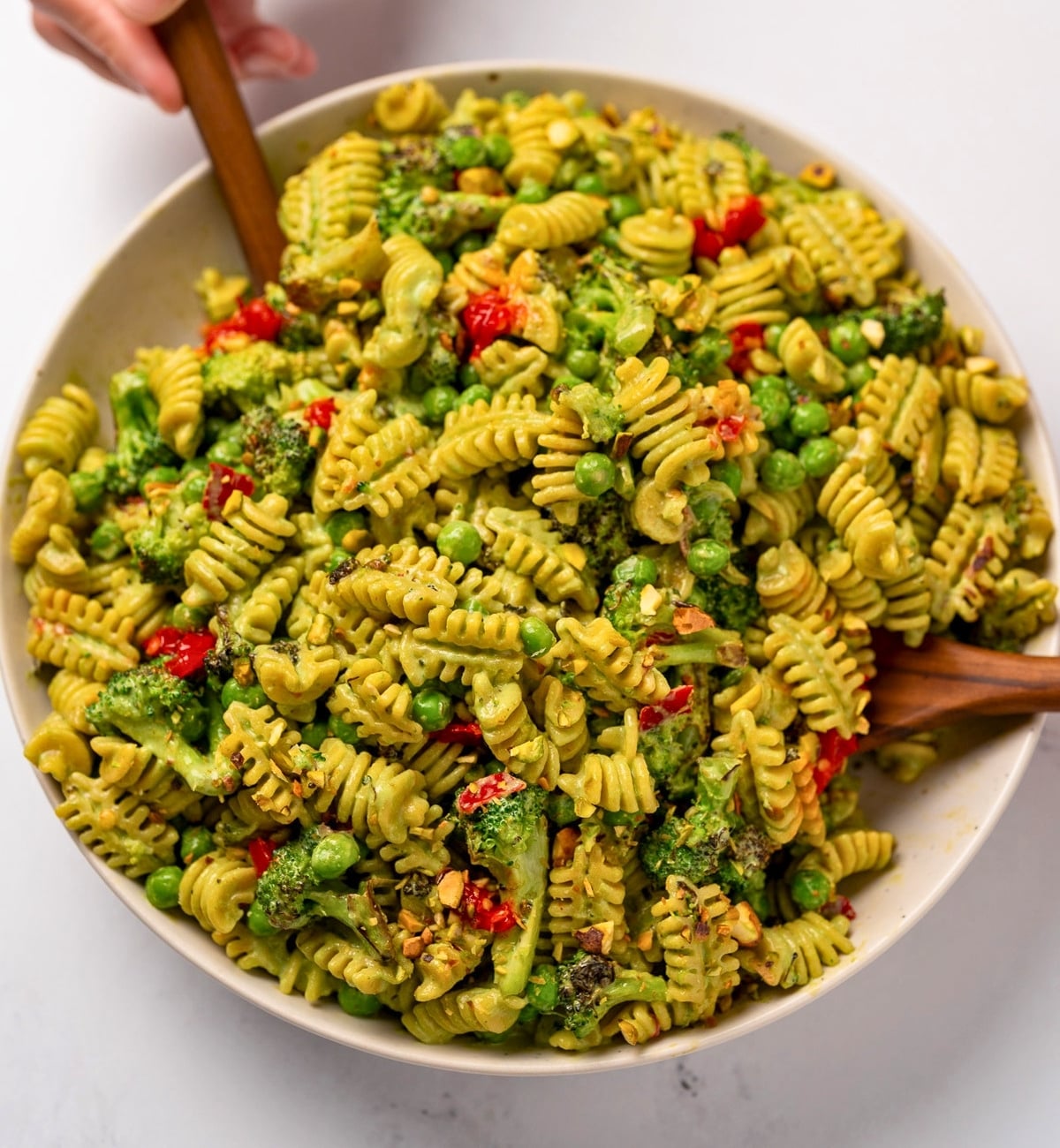 a bowl of roasted broccoli and cottage cheese pesto pasta salad