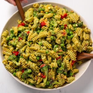 a bowl of roasted broccoli and cottage cheese pesto pasta salad