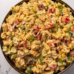 creamy feta pasta salad in a green bowl