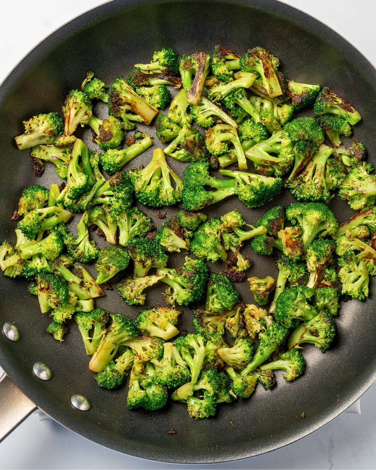 roasted broccoli bites in a nonstick pan