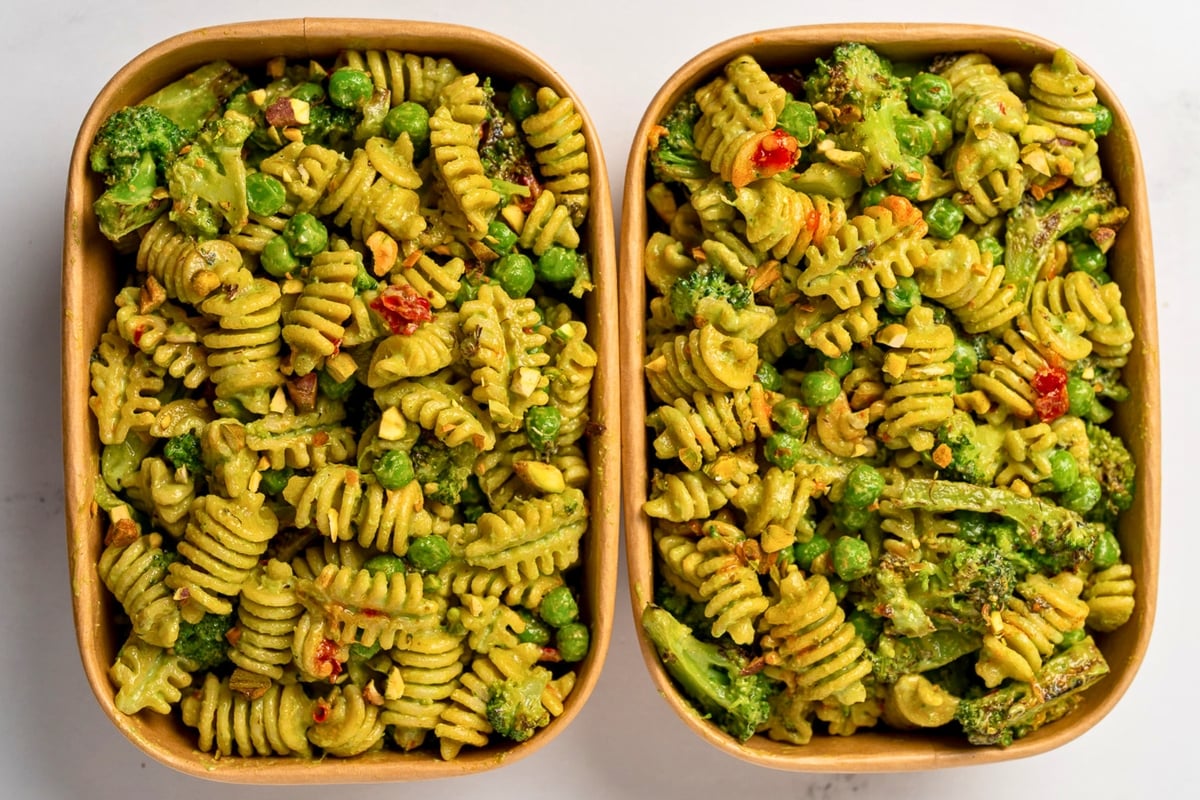 two meal prep containers with leftover pasta salad
