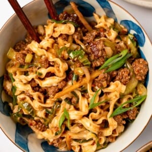 spicy ginger noodles in a bowl with chopsticks