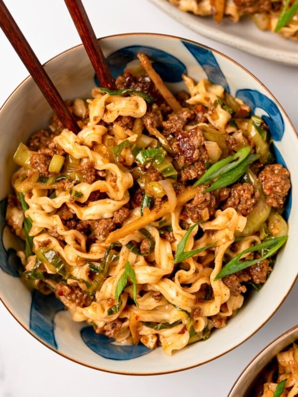 spicy ginger noodles in a bowl with chopsticks