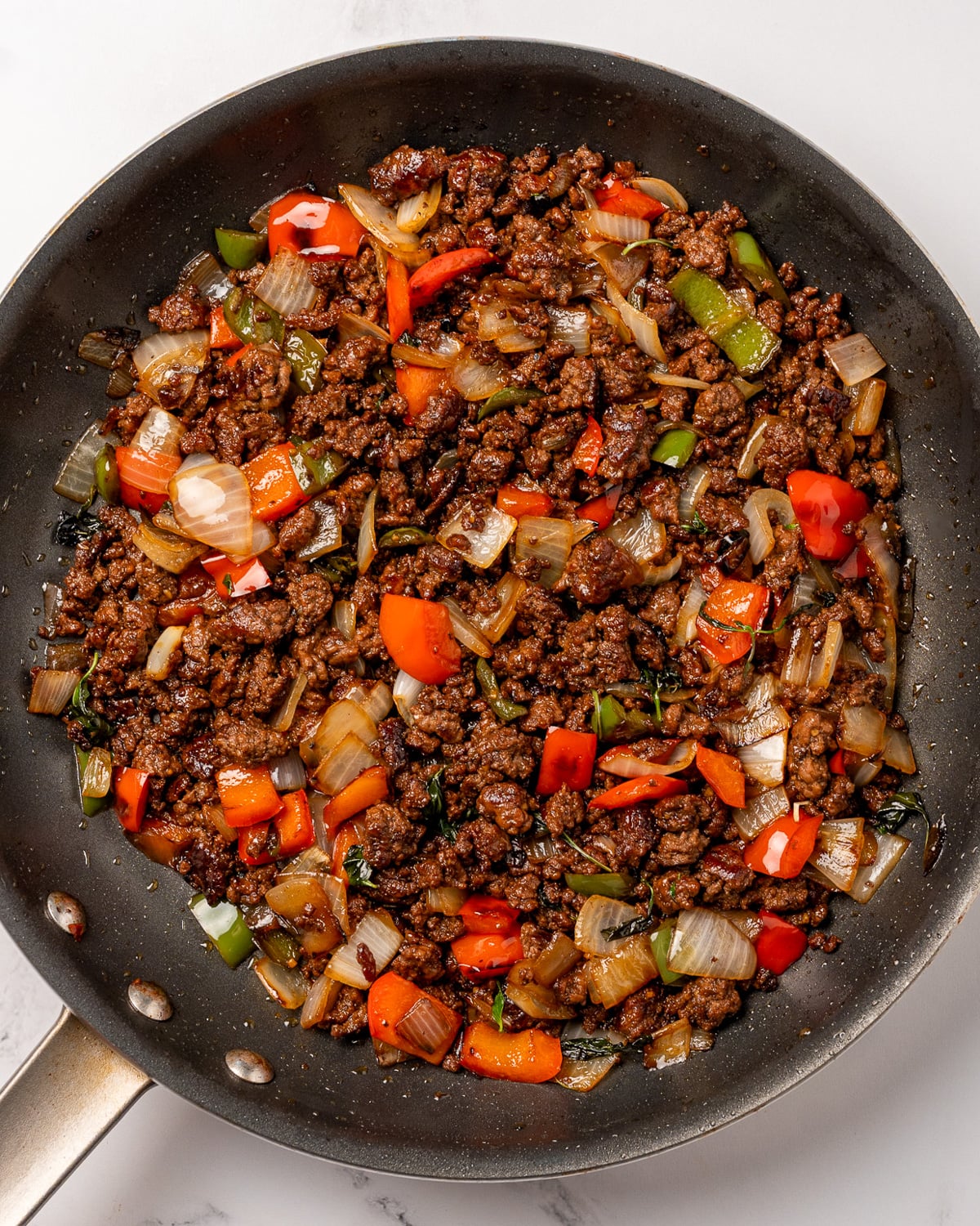 Thai basil ground beef stir fry in a nonstick pan