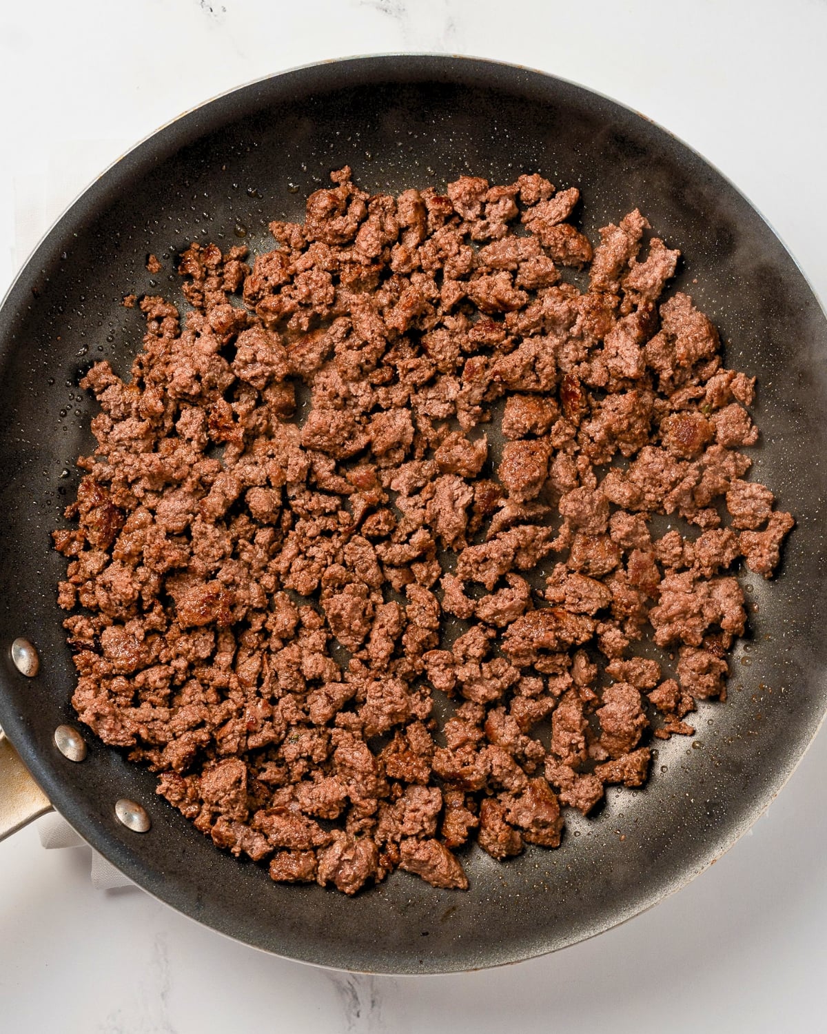 cooked ground beef in a nonstick pan