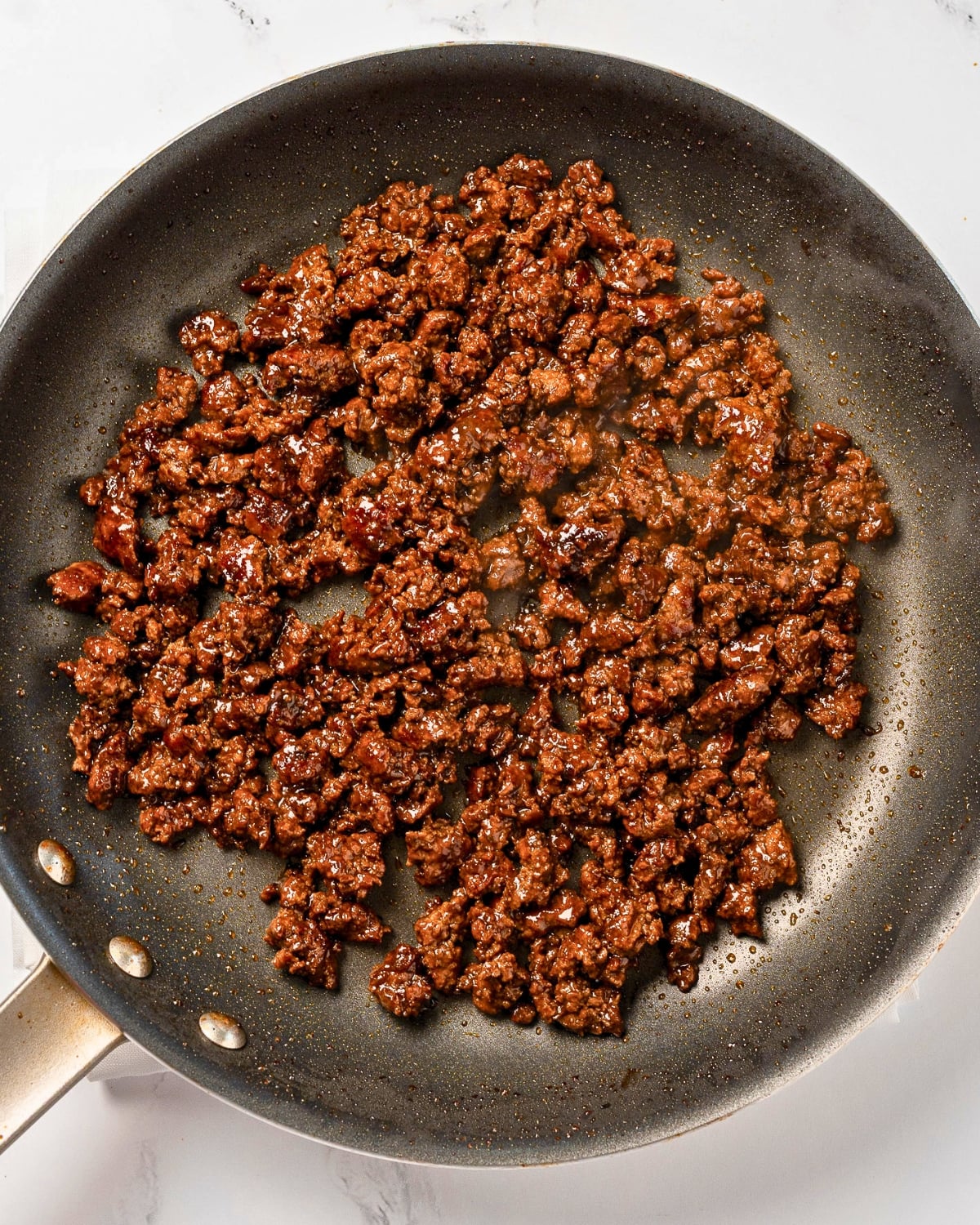 crispy ground beef crumbles in a nonstick pan