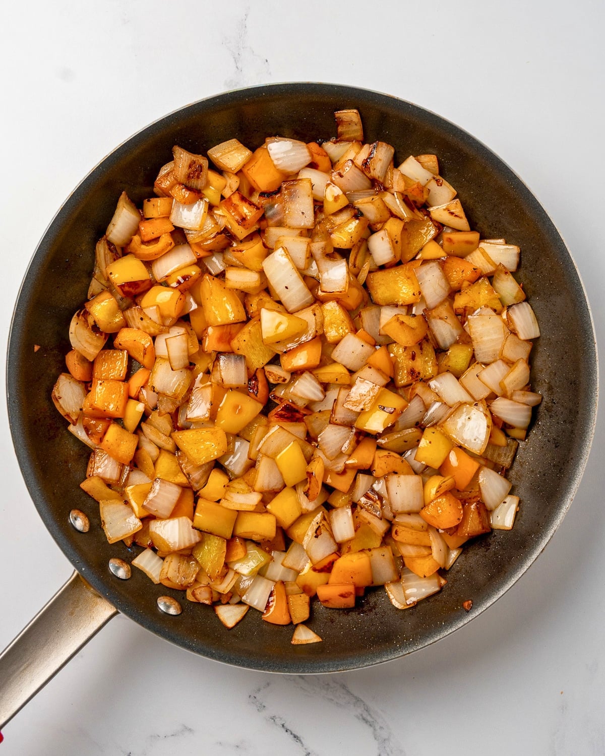 sautéed onion and bell pepper in a nonstick pan