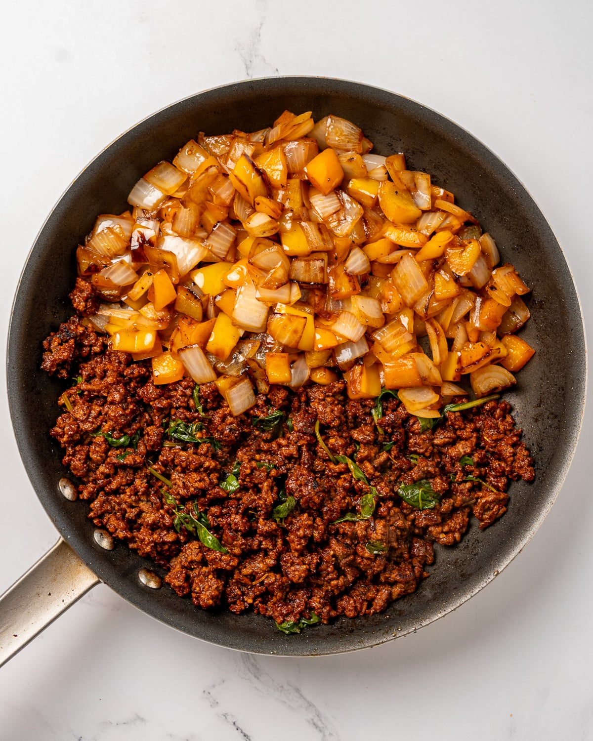 cooked ground beef and sautéed onion and bell peppers together in a nonstick pan