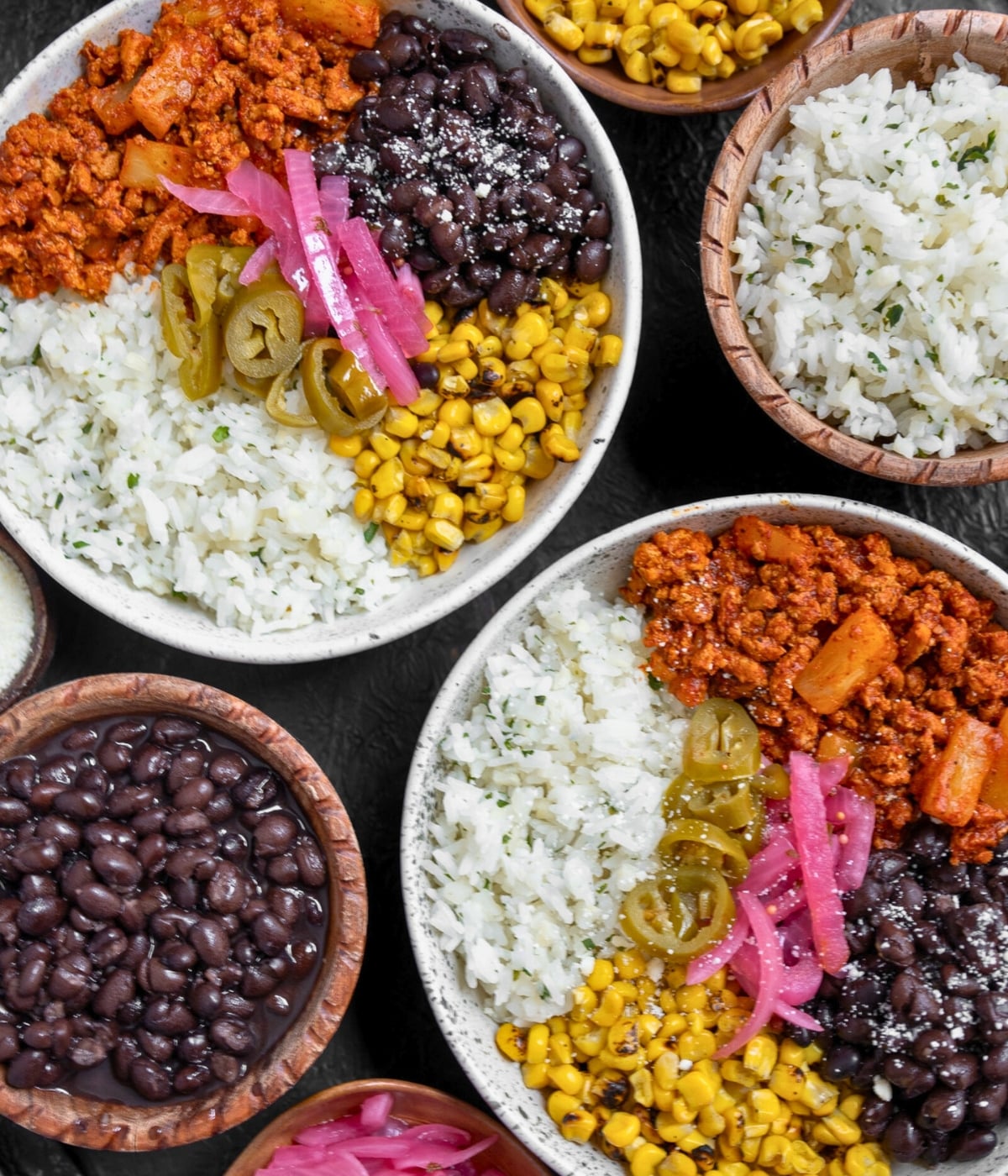 two al pastor ground turkey bowls with black beans, pickled onions and peppers, and rice
