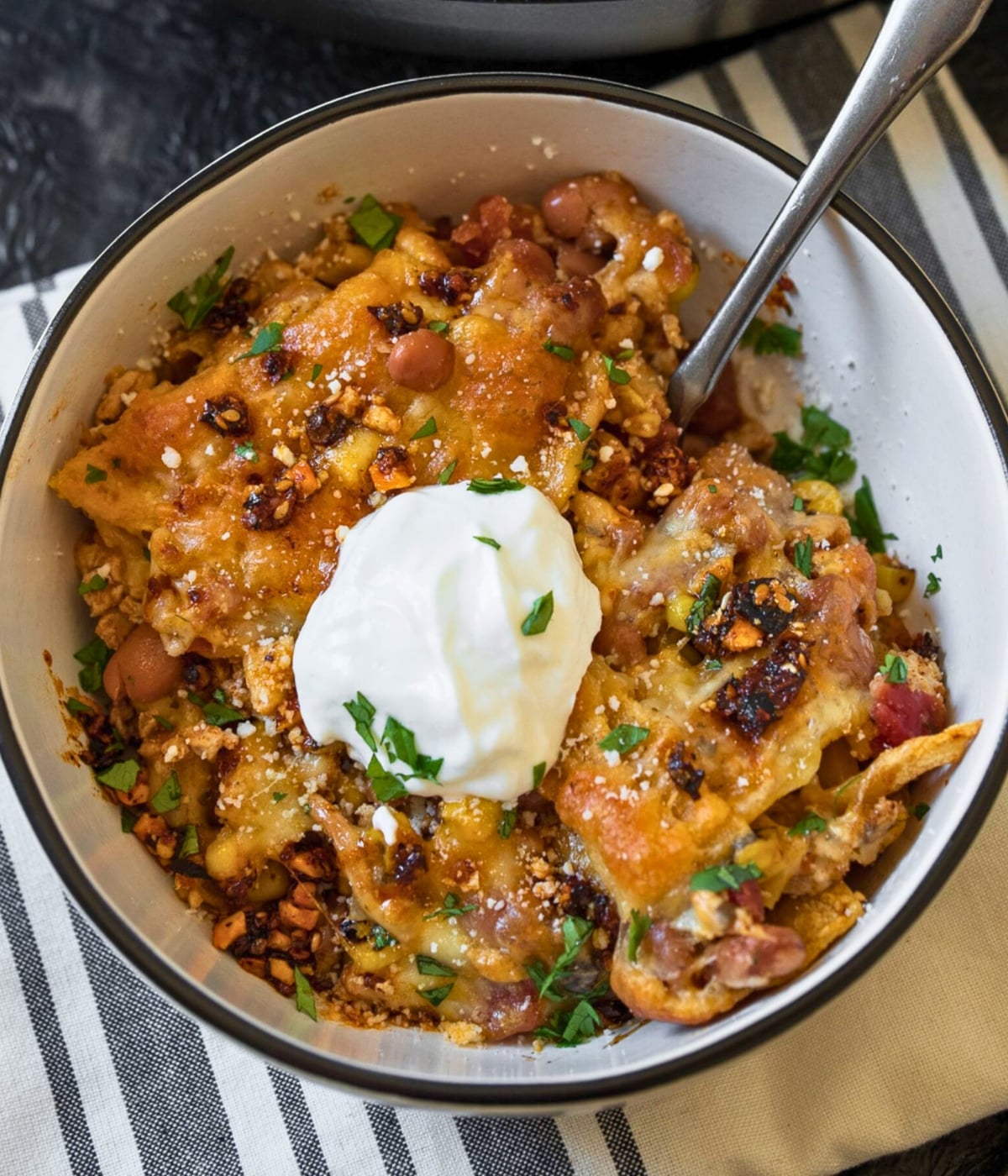 ground chicken casserole in a bowl garnished with nonfat Greek yogurt