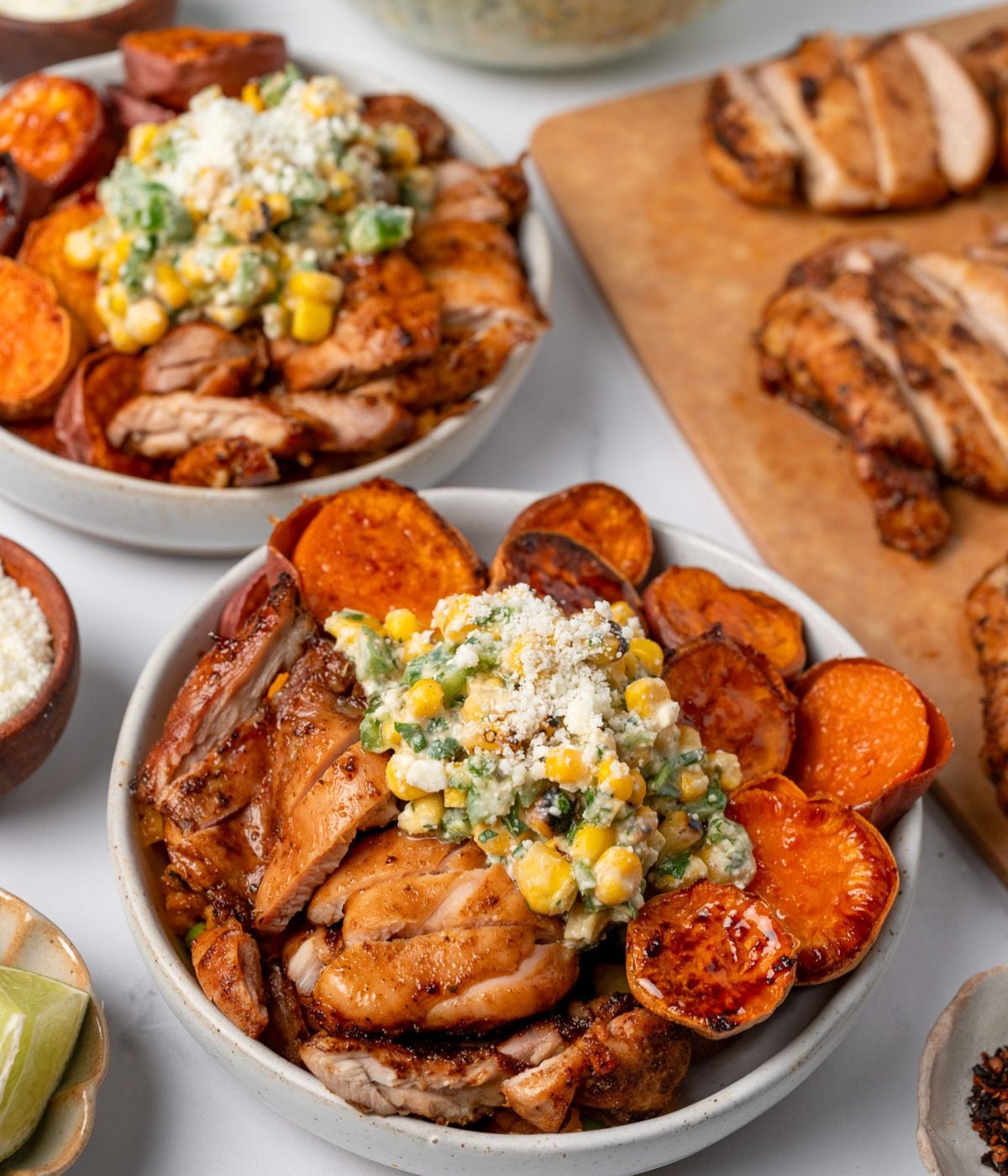 air fried chicken bowls with roasted sweet potatoes, street corn salad, and honey drizzle