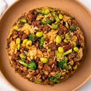 ground beef and broccoli fried rice in a shallow brown bowl