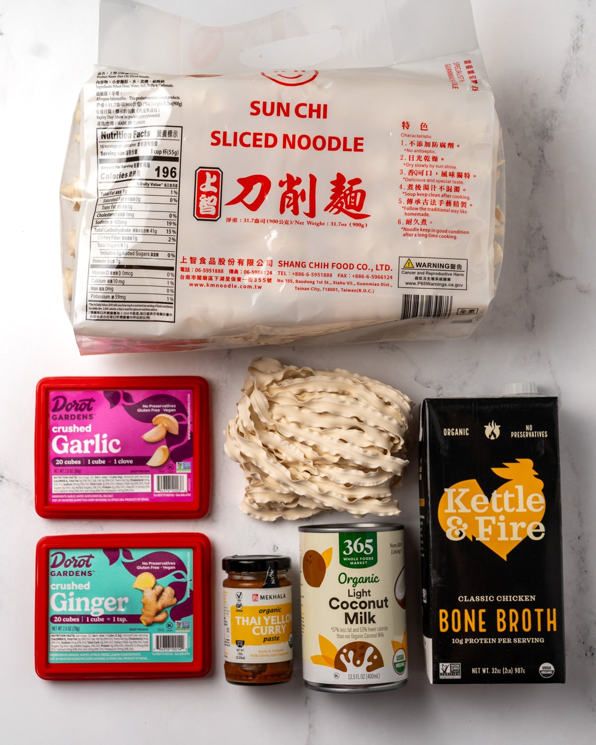 sliced noodles, frozen crushed garlic and ginger cubes, light coconut milk, Thai yellow curry paste, and chicken bone broth