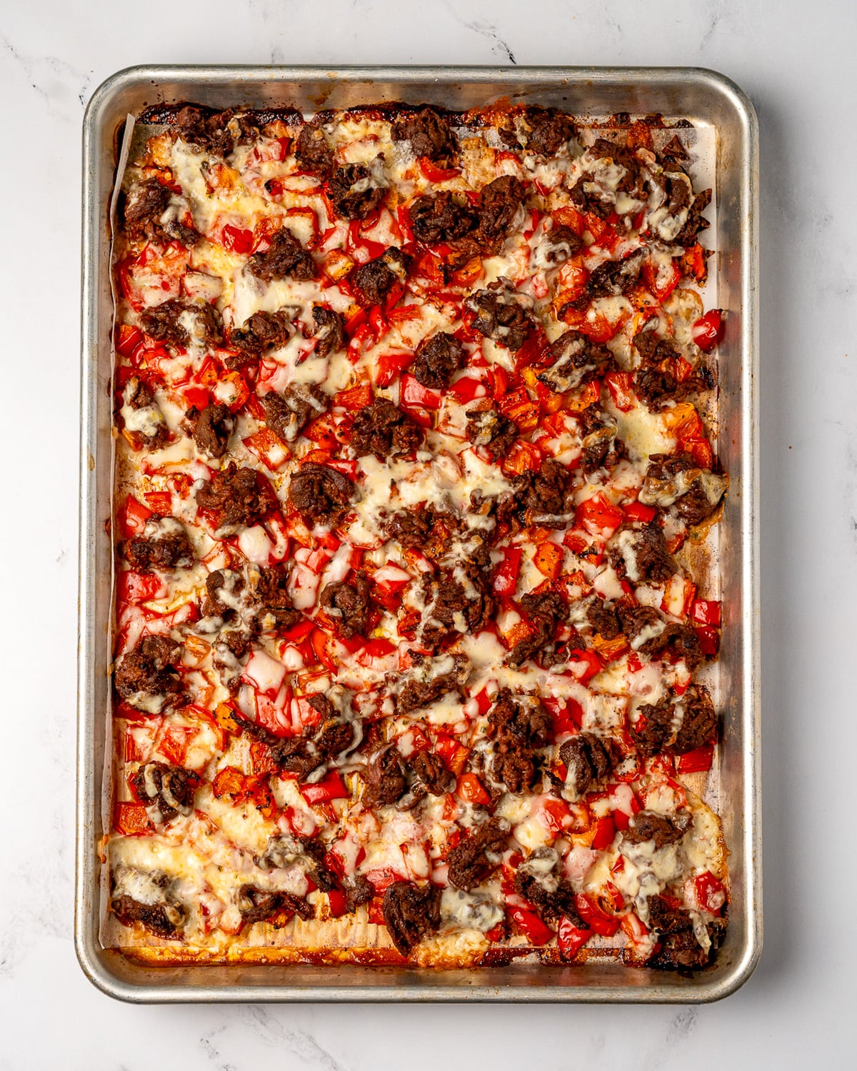 steak, peppers, and cheese on the sheet pan after the final bake