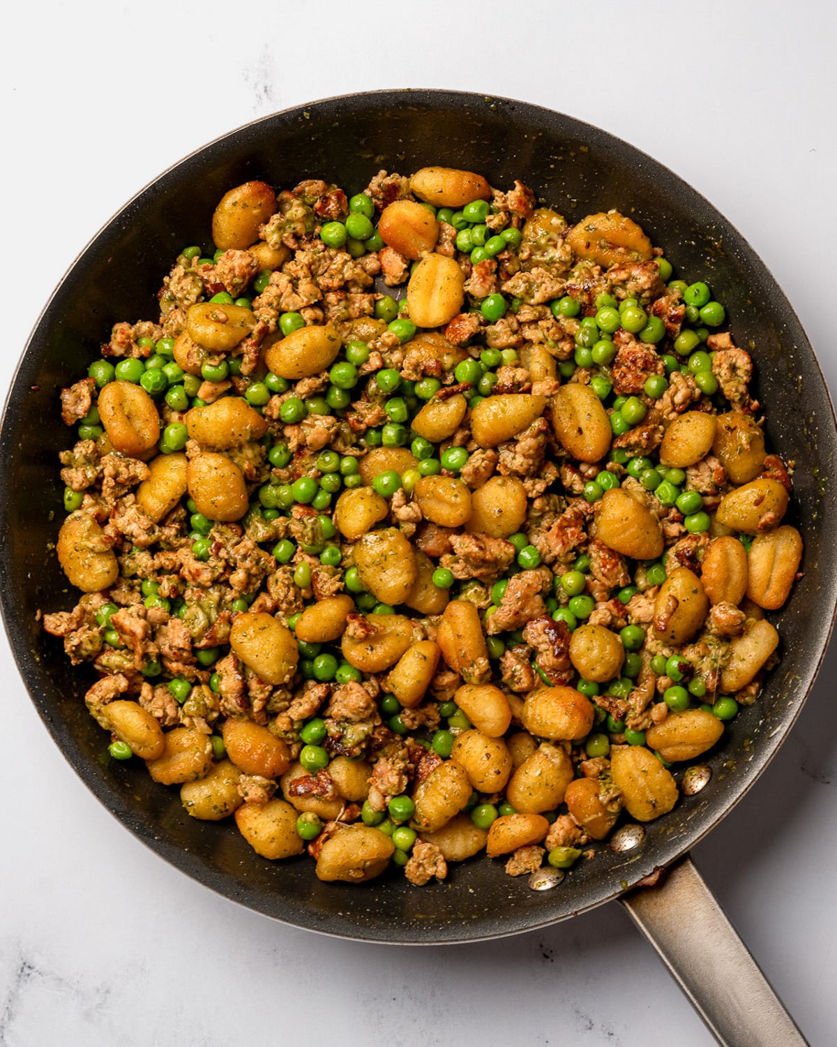 mixed chicken sausage and crispy gnocchi in a nonstick pan