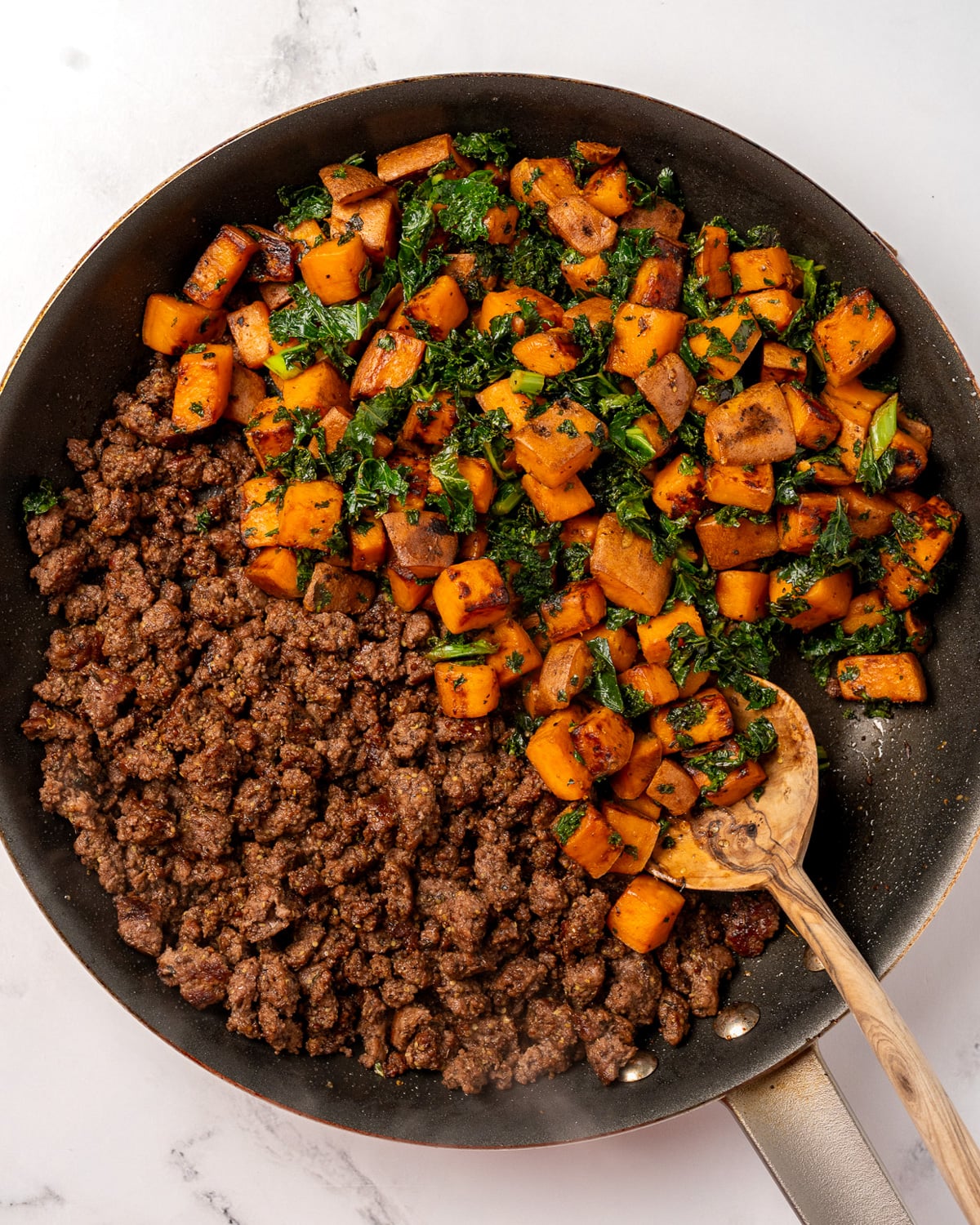 sweet potatoes and kale in a pan with extra lean ground beef