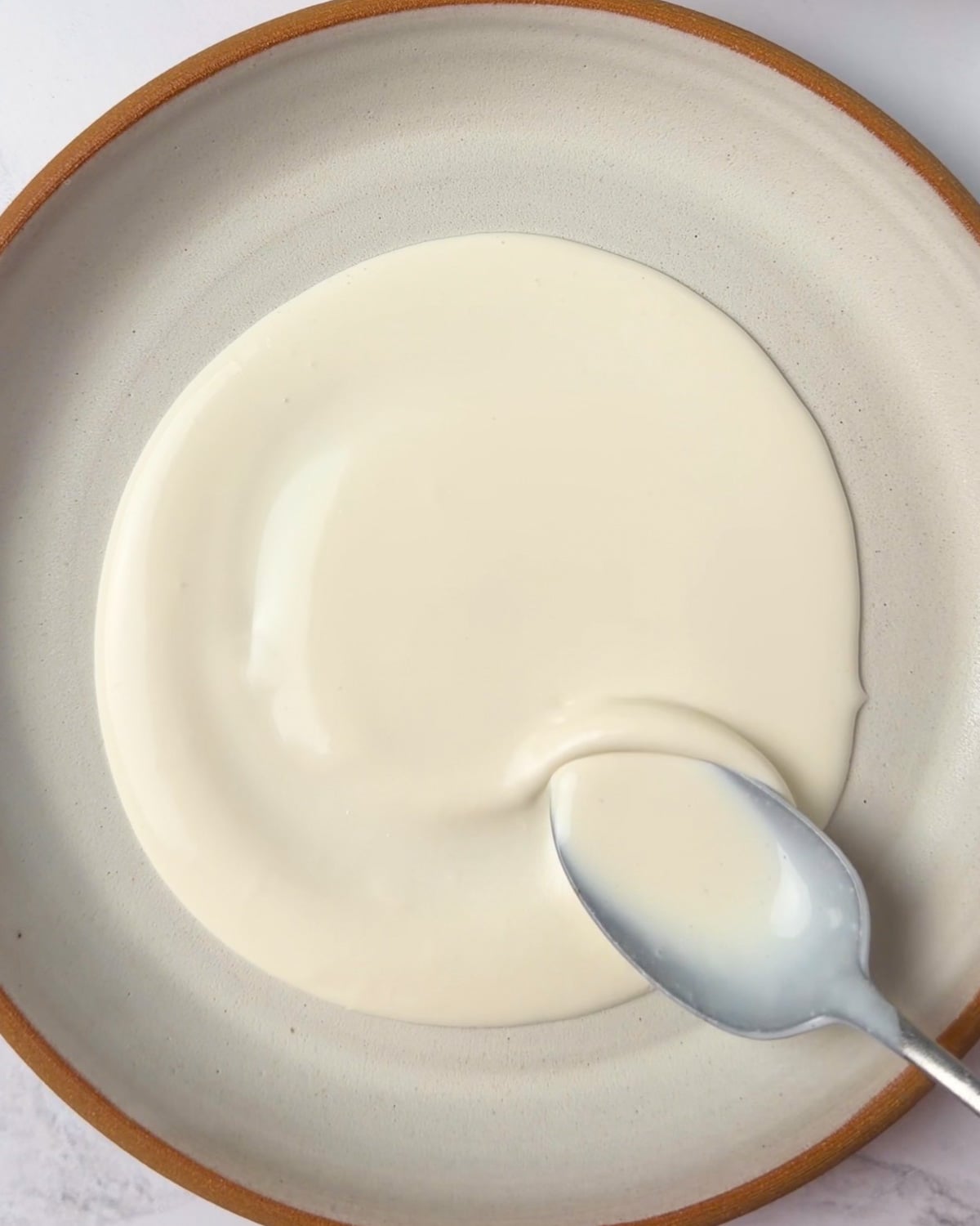 spreading whipped goat cheese on a plate