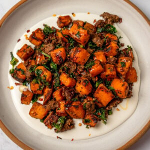 sautéed sweet potatoes and kale with ground beef served over whipped goat cheese