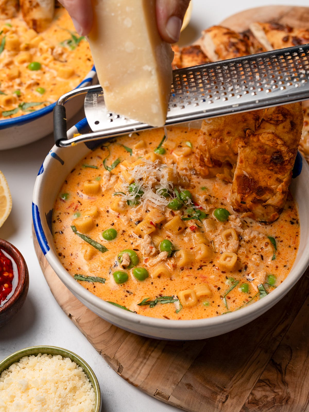 grated parmesan over a bowl of Italian chicken soup