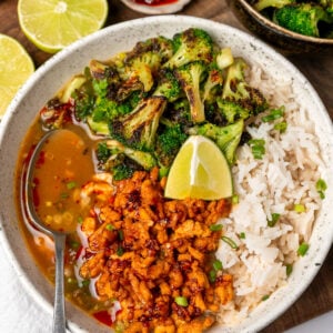 firecracker ground turkey in a bowl with steamed jasmine rice, pan roasted broccoli, miso ginger broth, and a lime wedge