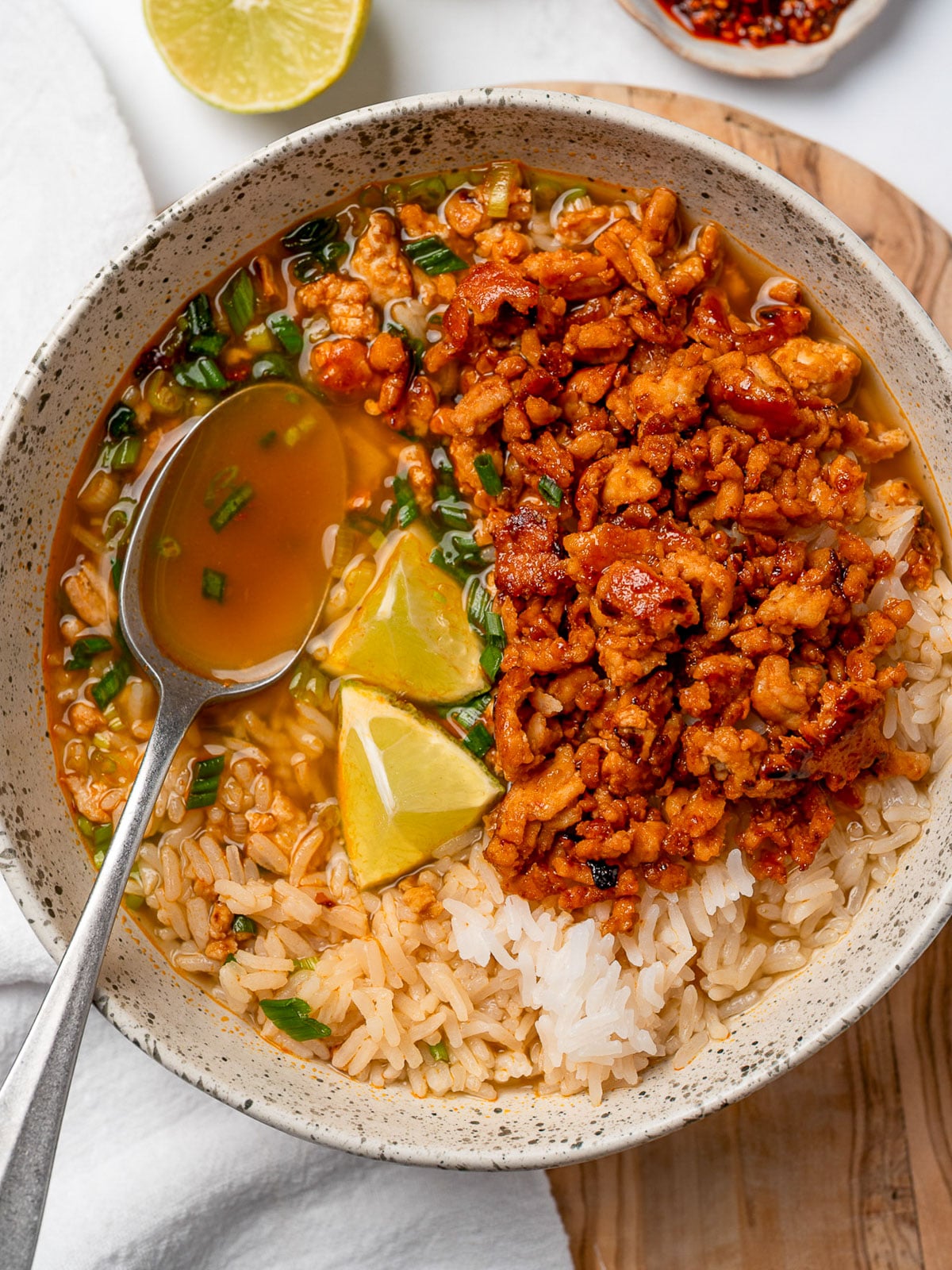eating a bowl of firecracker turkey brothy rice with a spoon