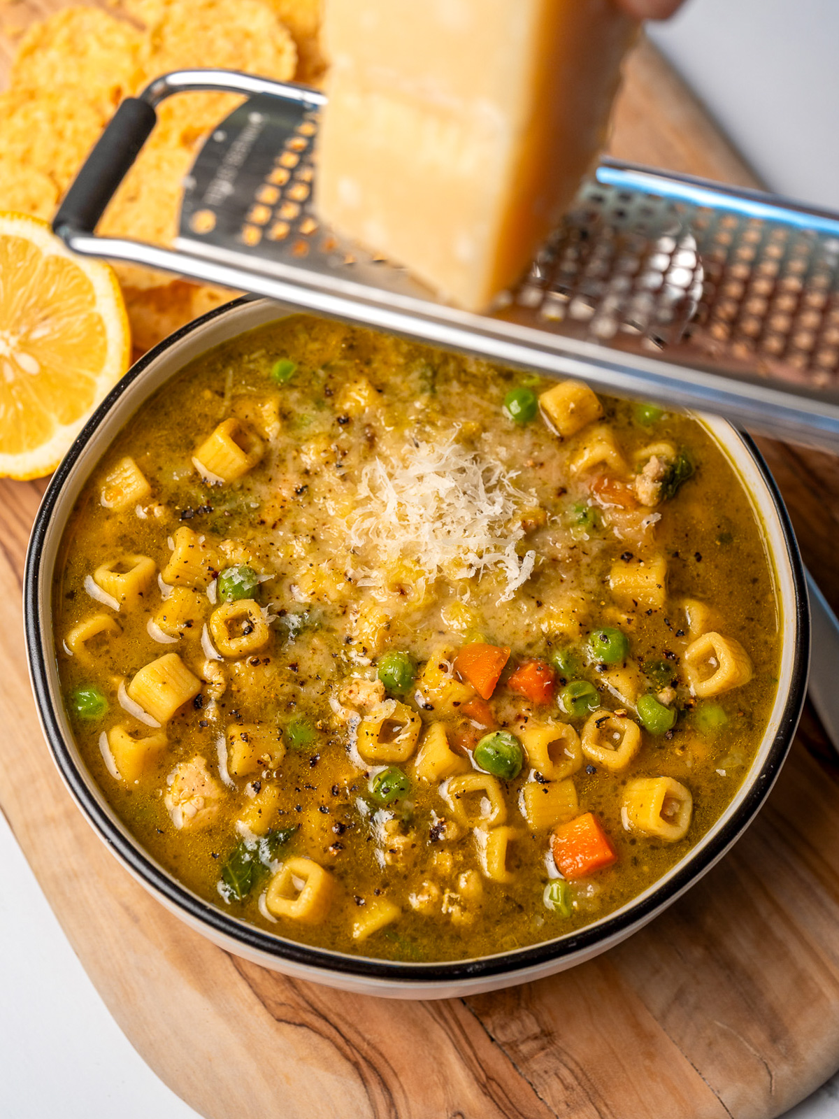grated parmesan over a bowl of chicken minestrone