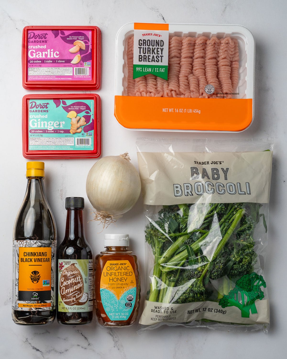 frozen cubes of crushed garlic and ginger, extra lean ground turkey, white onion, bag of baby broccoli, honey, coconut aminos, and Chinese black vinegar